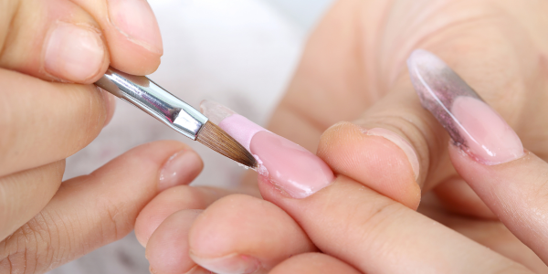 A woman getting nail care treatment at a nail salon near me