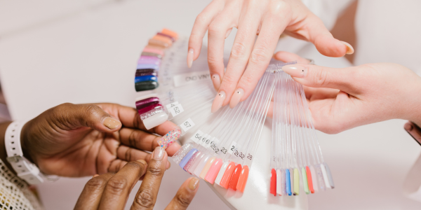 A woman selecting nail care treatment at a nail salon near me