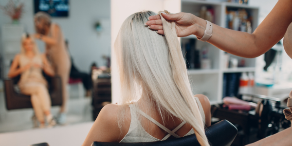 A woman getting her hair checked at a hairdressers near me